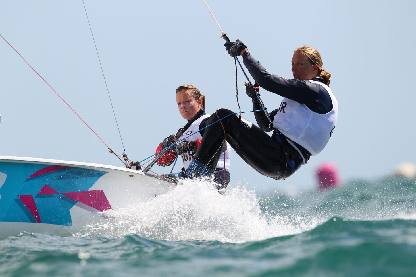 Hannah Mills (left) sails to silver with Saskia Clark